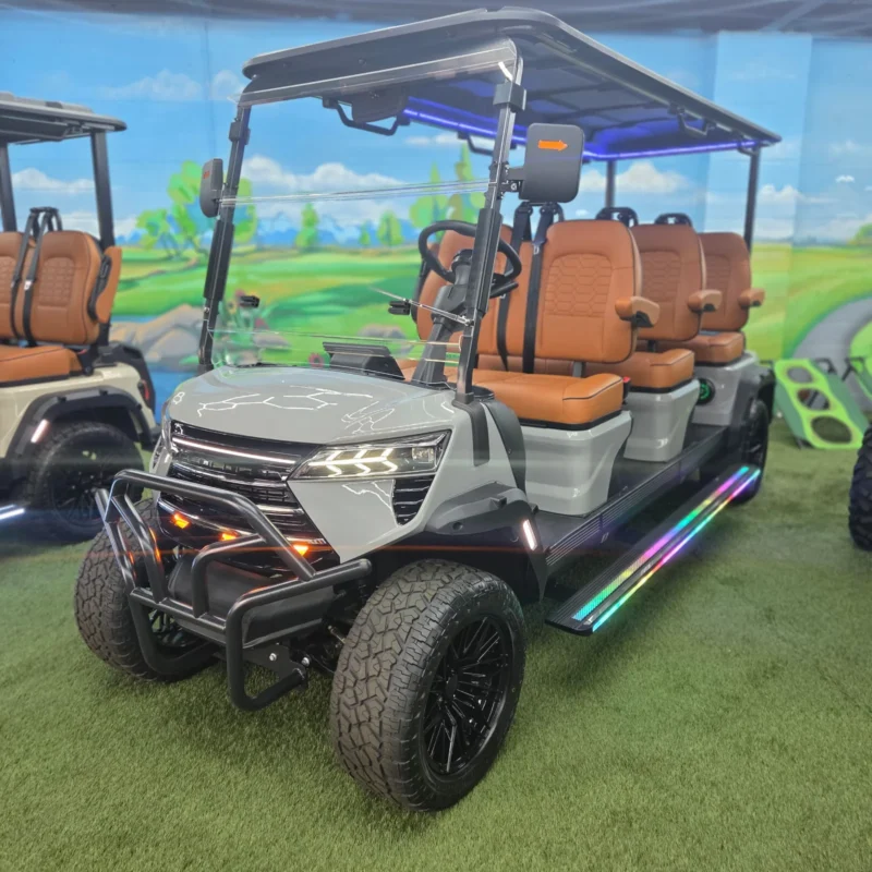 EDGE EV Phantom 6 six-seat golf cart in Nardo Gray with saddle brown seats, blue roof lights and rainbow LED running boards at the Family Golf Carts Dallas showroom