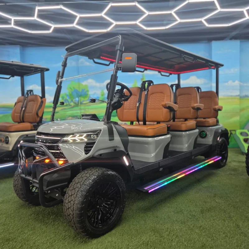 EDGE EV Phantom 6 six-seat golf cart in Nardo Gray with saddle brown seats, red roof lights and rainbow LED running boards at the Family Golf Carts Dallas showroom